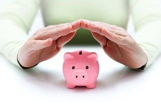 woman protecting savings in piggy bank