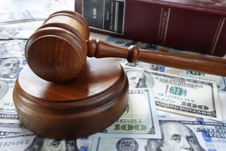 court gavel and money in lawsuit