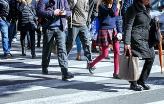 pedestrians crossing street in city