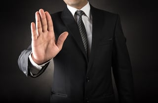 man with hand motion saying stop