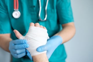 person with injured hand seeing doctor