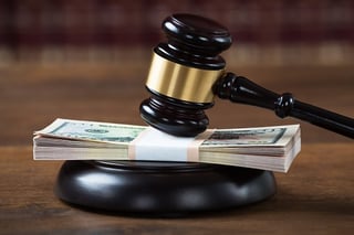 courtroom gavel with money