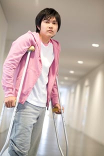 man on crutches in hospital