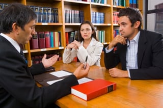 injury lawyer talking with man and woman