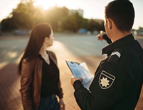police-officer-shows-parking-place-to-driver-7DSTRWL