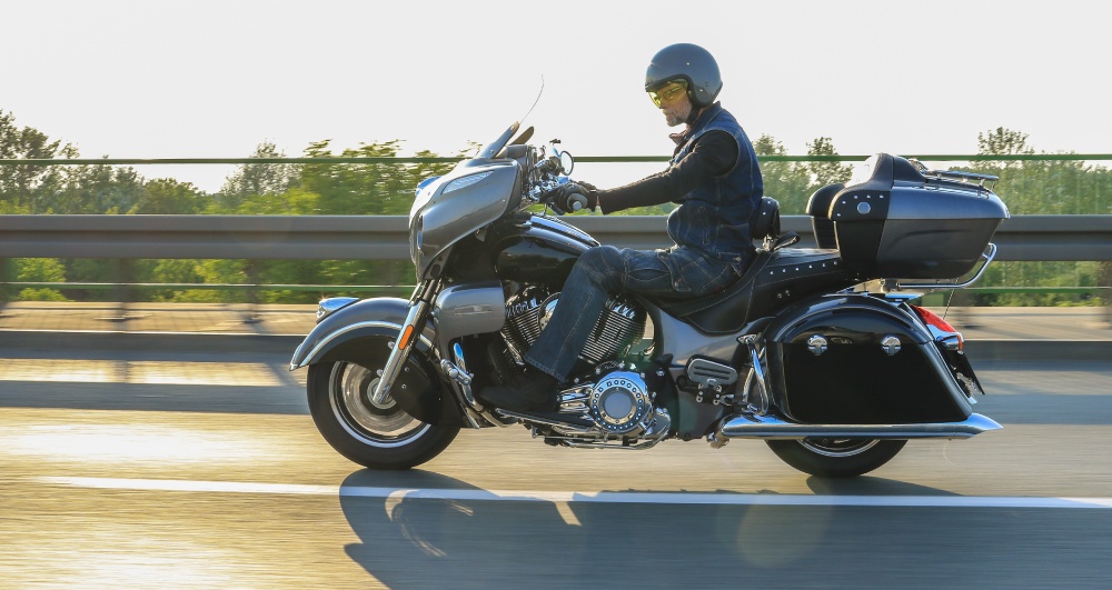 Motorcyclist-riding-his-motorcycle-in-setting-sun