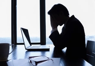 Nervous_businessman_at_desk