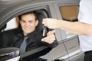 man getting keys to car