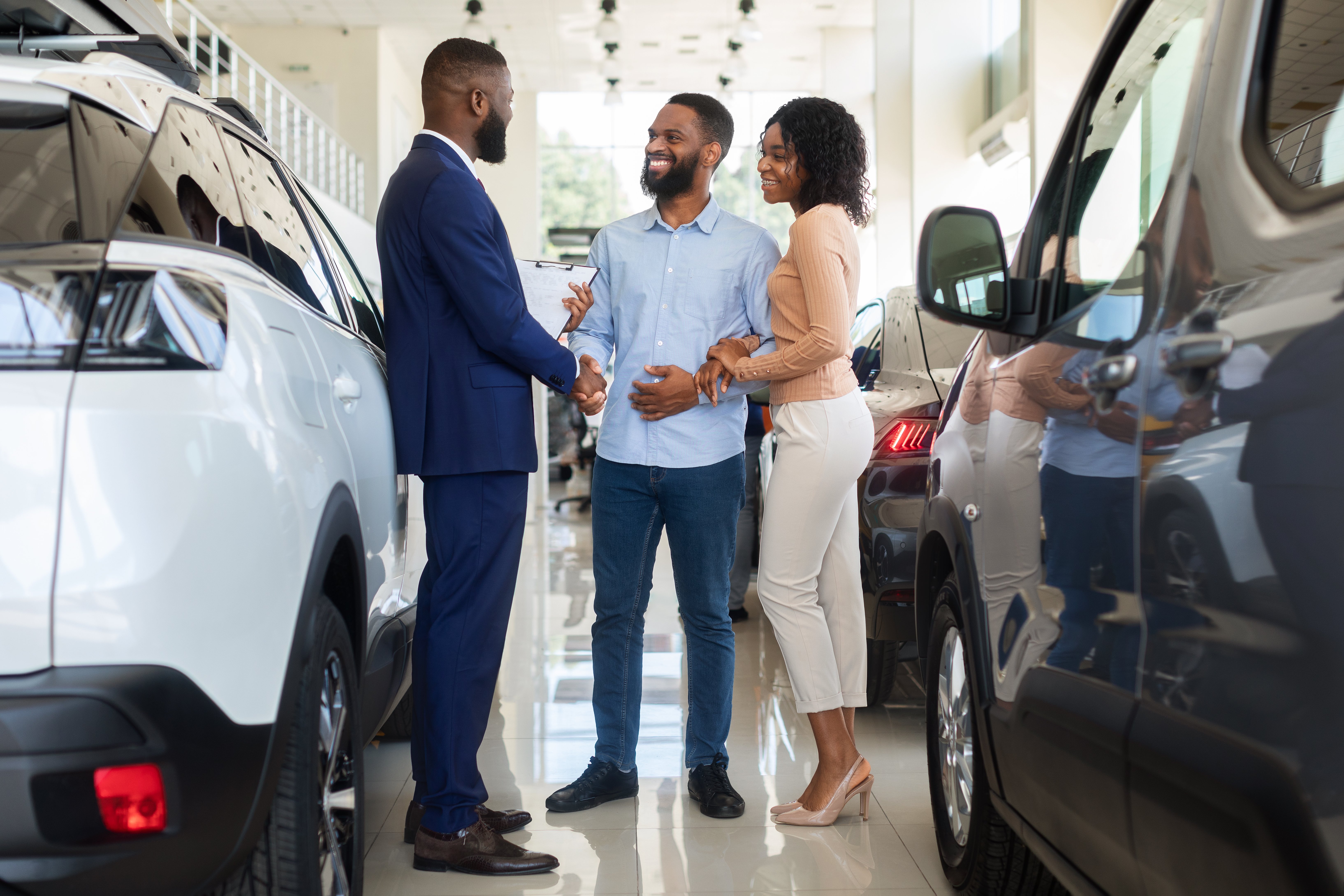 car-purchase-happy-customers-couple-handshaking-w-2022-12-16-07-13-40-utc