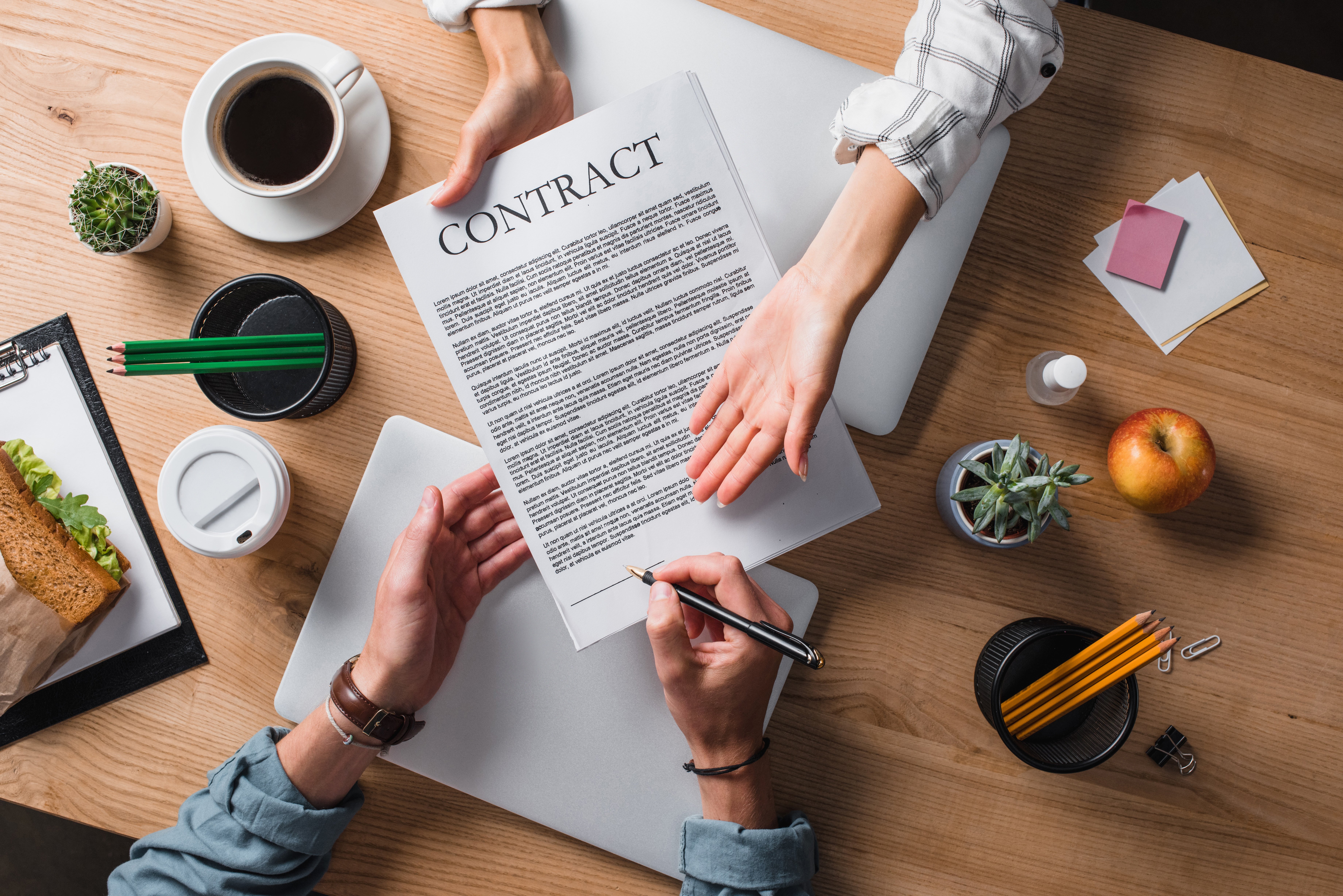 cropped-shot-of-businesspeople-signing-contract-at-2023-11-27-05-28-46-utc