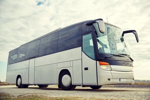 tour-bus-driving-outdoors-PYK8KJ6