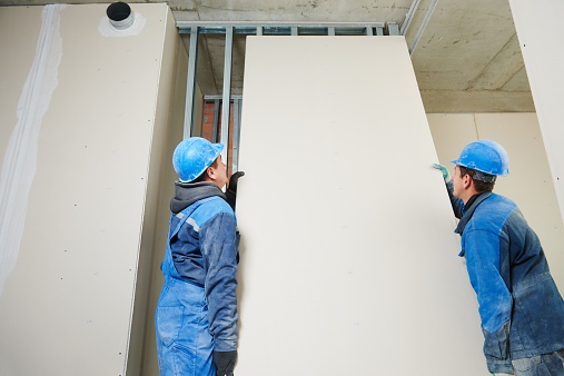 workers installing drywall