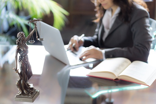 lawyer on laptop working on involuntary bankruptcy case